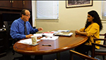 photo of a mentor and mentee seated at a table